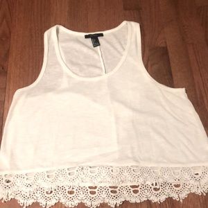 Whit tank top with detailing around the bottom
